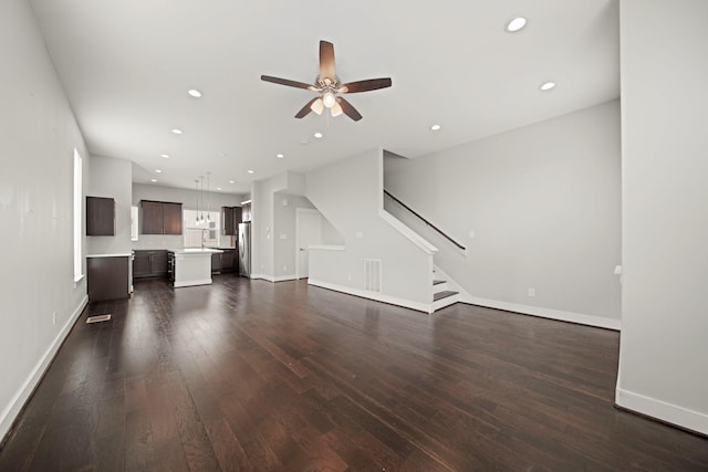 703 Schwartz St, Houston, TX 77020 - unfurnished living room with a ceiling fan, stairway, dark wood finished floors, and recessed lighting