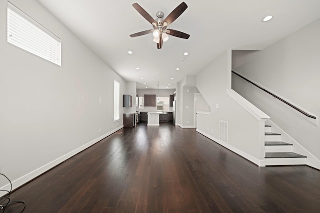 703 Schwartz St, Houston, TX 77020 - unfurnished living room featuring ceiling fan, dark wood-style floors, stairway, and recessed lighting