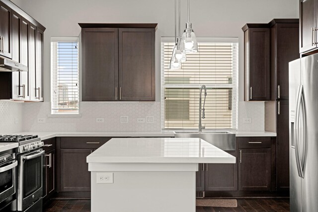 703 Schwartz St, Houston, TX 77020 - kitchen featuring stainless steel appliances, dark wood-type flooring, and dark brown cabinetry