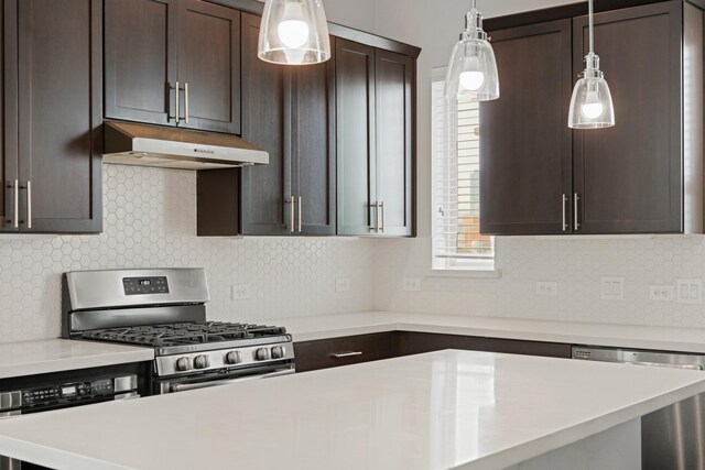 703 Schwartz St, Houston, TX 77020 - kitchen featuring appliances with stainless steel finishes, under cabinet range hood, dark brown cabinetry, light countertops, and decorative backsplash