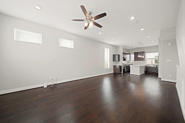 703 Schwartz St, Houston, TX 77020 - unfurnished living room featuring dark wood finished floors, ceiling fan, and recessed lighting