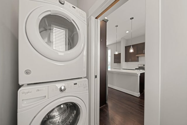 703 Schwartz St, Houston, TX 77020 - laundry room with stacked washer and clothes dryer and dark wood-type flooring