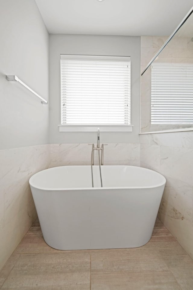 703 Schwartz St, Houston, TX 77020 - bathroom with a freestanding tub and tile walls