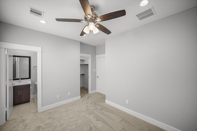 703 Schwartz St, Houston, TX 77020 - unfurnished bedroom featuring light carpet, recessed lighting, ensuite bathroom, a walk in closet, and a ceiling fan