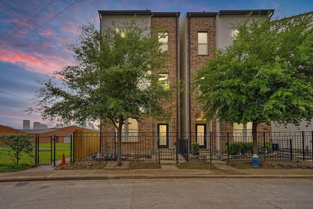 703 Schwartz St, Houston, TX 77020 - view of front of home featuring a gate, brick siding, and stucco siding
