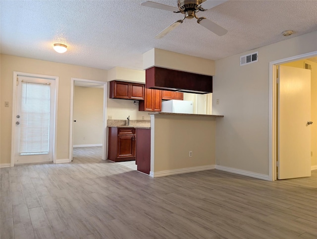 2750 Holly Hall St Unit 1504, Houston, TX 77054 - kitchen featuring freestanding refrigerator, a ceiling fan, light wood-type flooring, a textured ceiling, and light countertops