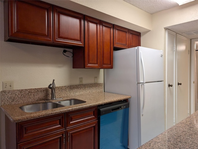 2750 Holly Hall St Unit 1504, Houston, TX 77054 - kitchen with dishwasher, freestanding refrigerator, light stone counters, and dark brown cabinets
