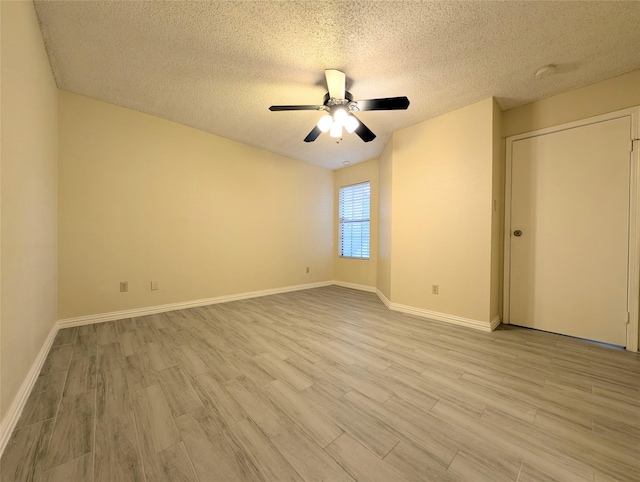 2750 Holly Hall St Unit 1504, Houston, TX 77054 - unfurnished bedroom with wood finished floors, a textured ceiling, and a ceiling fan