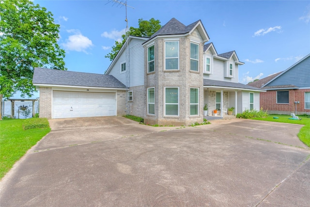 440 Lakeview Drive Loop, Coldspring, TX 77331 - victorian house featuring concrete driveway, an attached garage, a front yard, covered porch, and brick siding