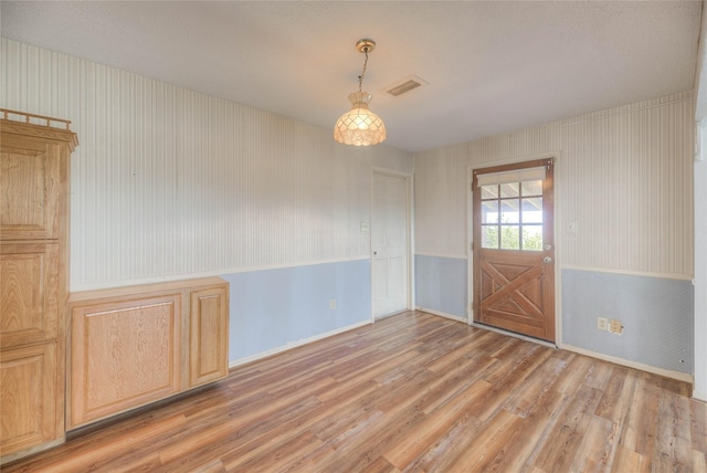 440 Lakeview Drive Loop, Coldspring, TX 77331 - unfurnished dining area with wallpapered walls and light wood-style floors