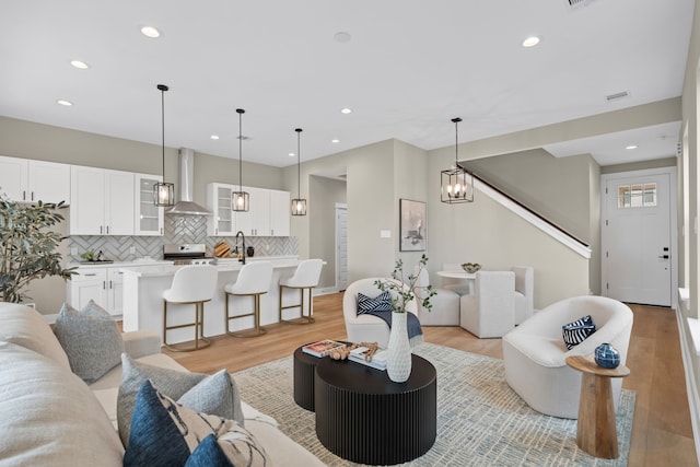 5935 Cebra, Houston, TX 77091 - living room with recessed lighting, light wood-style floors, and stairway