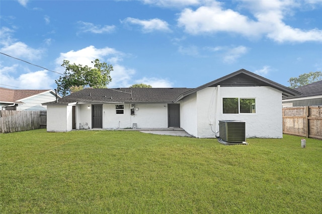 5854 Schevers St, Houston, TX 77033 - rear view of house with stucco siding, a fenced backyard, and a patio