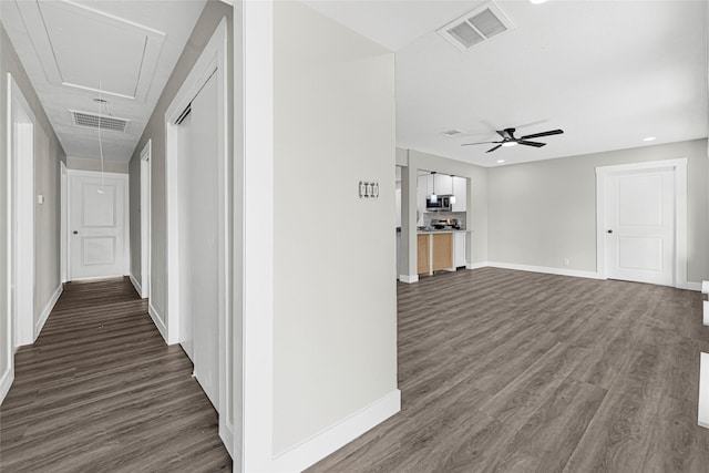 5854 Schevers St, Houston, TX 77033 - corridor featuring attic access and dark wood-style floors