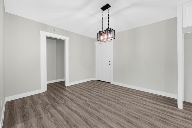 5854 Schevers St, Houston, TX 77033 - unfurnished dining area featuring dark wood-type flooring and a chandelier