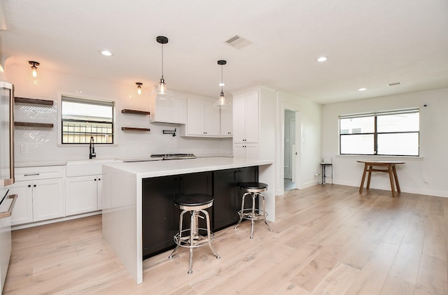 2826 Durban Dr, Houston, TX 77043 - kitchen featuring open shelves, light countertops, white cabinetry, plenty of natural light, and recessed lighting
