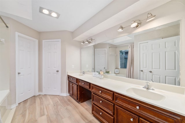 7238 N Hearthstone Green Dr, Houston, TX 77095 - full bath featuring double vanity, a tub, wood finished floors, and a shower with curtain