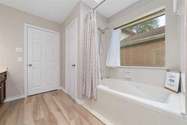7238 N Hearthstone Green Dr, Houston, TX 77095 - bathroom featuring vanity, wood finished floors, and shower / tub combo with curtain