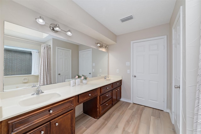 7238 N Hearthstone Green Dr, Houston, TX 77095 - bathroom with double vanity, wood finished floors, and a shower with shower curtain