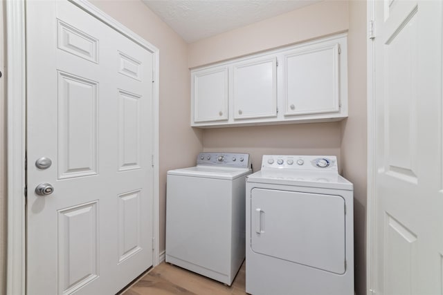 7238 N Hearthstone Green Dr, Houston, TX 77095 - laundry room featuring independent washer and dryer, cabinet space, and light wood-style floors