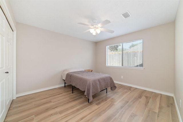 7238 N Hearthstone Green Dr, Houston, TX 77095 - bedroom featuring light wood-type flooring, a closet, and ceiling fan