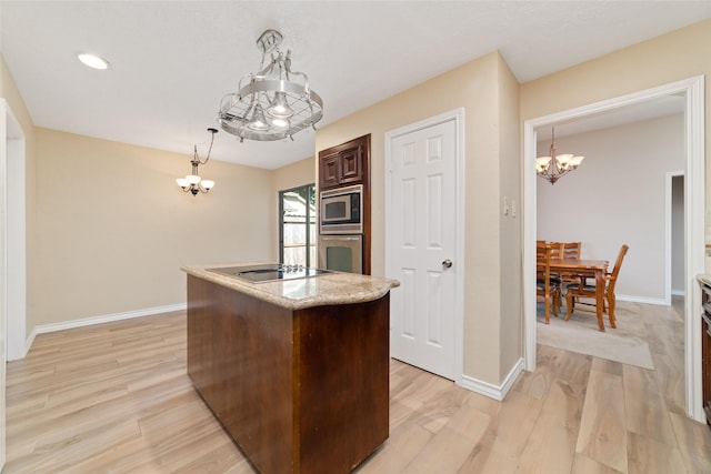 7238 N Hearthstone Green Dr, Houston, TX 77095 - kitchen with a chandelier, appliances with stainless steel finishes, a center island, and light wood-type flooring