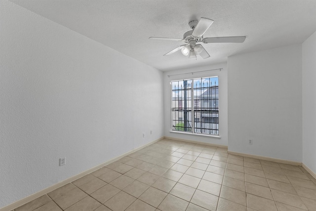 6606 De Moss Dr Unit 1406, Houston, TX 77074 - empty room with ceiling fan, light tile patterned floors, and a textured ceiling
