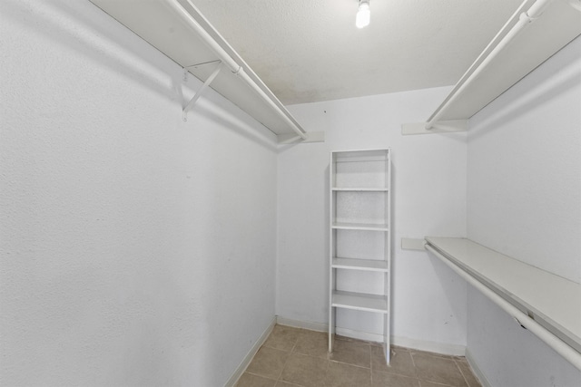 6606 De Moss Dr Unit 1406, Houston, TX 77074 - walk in closet with tile patterned floors