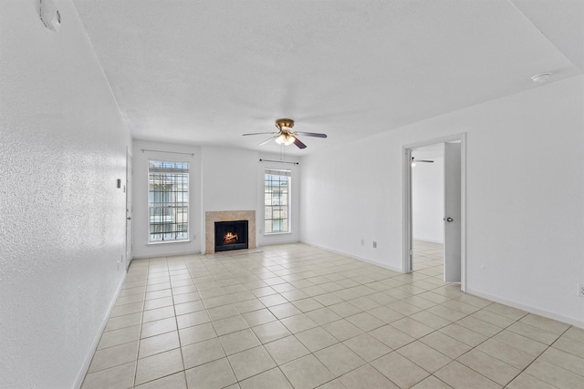 6606 De Moss Dr Unit 1406, Houston, TX 77074 - unfurnished living room featuring ceiling fan, light tile patterned floors, and a fireplace