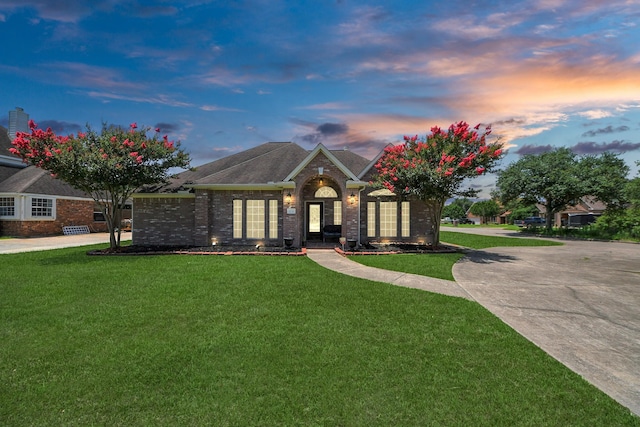 5231 S Fm 565th Rd, Cove, TX 77523 - view of front of house featuring brick siding and a front lawn