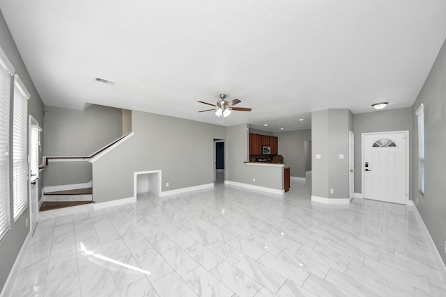14722 Scenic Sky Way, Houston, TX 77049 - unfurnished living room featuring light marble finish flooring, plenty of natural light, a ceiling fan, and recessed lighting