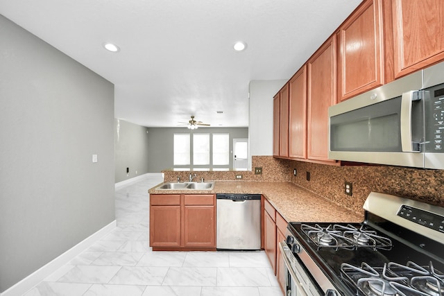 14722 Scenic Sky Way, Houston, TX 77049 - kitchen featuring stainless steel appliances, light marble finish flooring, ceiling fan, a peninsula, and brown cabinetry