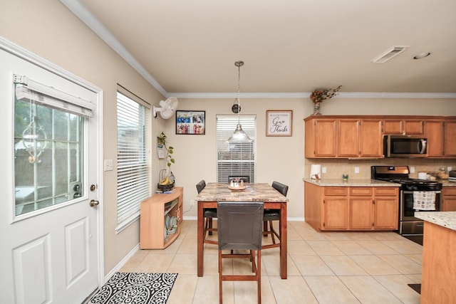 20310 Port Bishop Ln, Richmond, TX 77407 - kitchen with appliances with stainless steel finishes, light countertops, light tile patterned floors, decorative backsplash, and ornamental molding