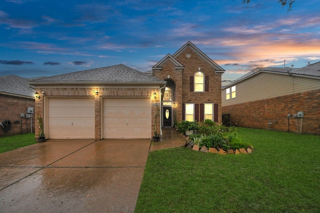 20310 Port Bishop Ln, Richmond, TX 77407 - traditional home featuring concrete driveway, an attached garage, a lawn, and brick siding