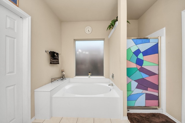 20310 Port Bishop Ln, Richmond, TX 77407 - bathroom with a garden tub, a shower, and tile patterned floors