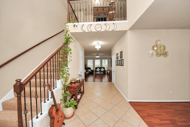 20310 Port Bishop Ln, Richmond, TX 77407 - foyer with stairway, a towering ceiling, and light tile patterned flooring
