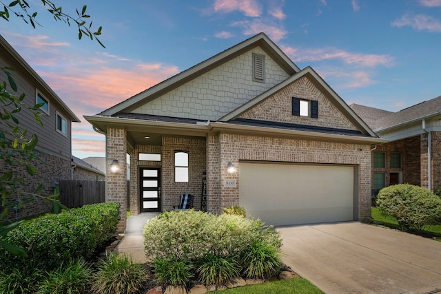 31230 Pinebrook Falls Ln SE, Hockley, TX 77447 - view of front facade with brick siding, an attached garage, and concrete driveway