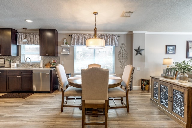 11823 Solon Springs Dr, Tomball, TX 77375 - dining space with a textured ceiling, crown molding, light wood-style flooring, and recessed lighting