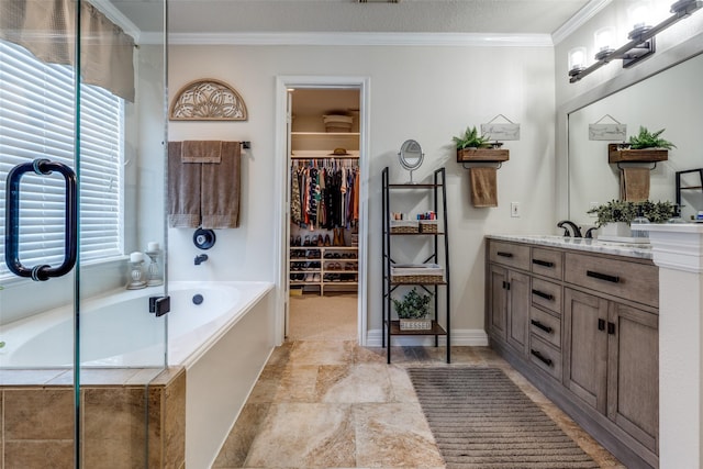 11823 Solon Springs Dr, Tomball, TX 77375 - full bath with double vanity, a garden tub, crown molding, stone finish floors, and a walk in closet