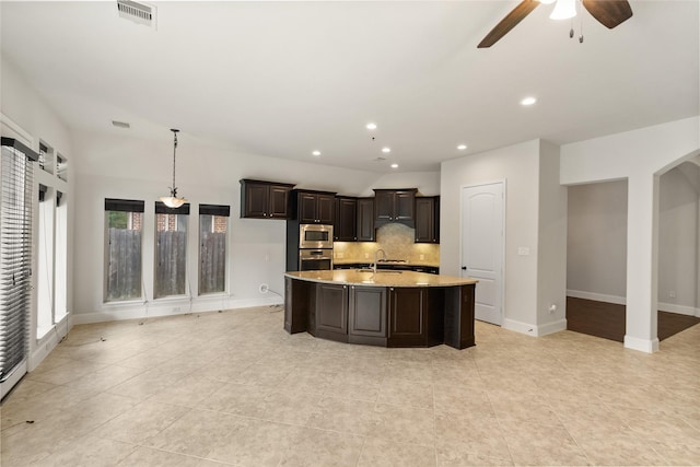 23411 Reynolds Pond Dr, New Caney, TX 77357 - kitchen featuring appliances with stainless steel finishes, decorative backsplash, a ceiling fan, light tile patterned floors, and recessed lighting
