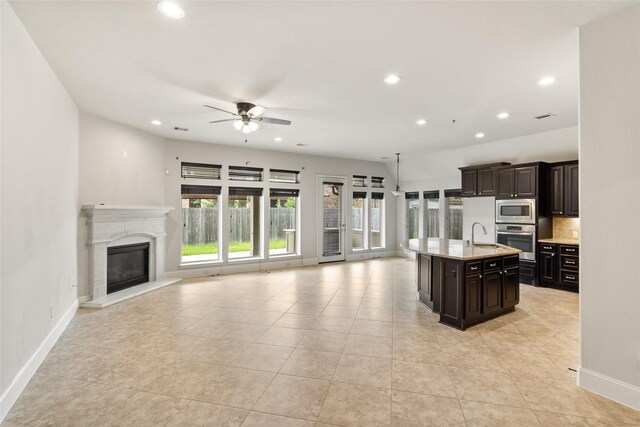 23411 Reynolds Pond Dr, New Caney, TX 77357 - kitchen featuring appliances with stainless steel finishes, open floor plan, recessed lighting, ceiling fan, and a kitchen island with sink
