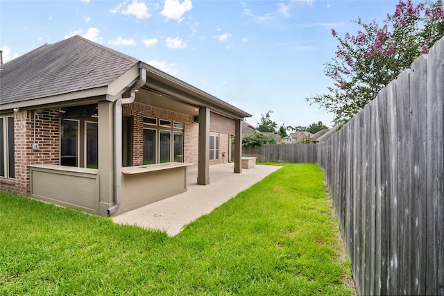 23411 Reynolds Pond Dr, New Caney, TX 77357 - rear view of property featuring brick siding, a patio area, a shingled roof, and a fenced backyard