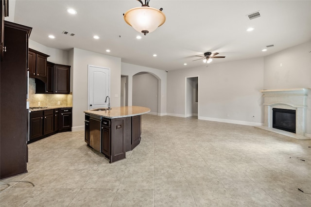 23411 Reynolds Pond Dr, New Caney, TX 77357 - kitchen with a ceiling fan, arched walkways, tasteful backsplash, open floor plan, and recessed lighting