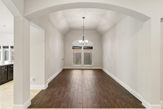 23411 Reynolds Pond Dr, New Caney, TX 77357 - unfurnished dining area featuring wood finished floors, a chandelier, arched walkways, and lofted ceiling