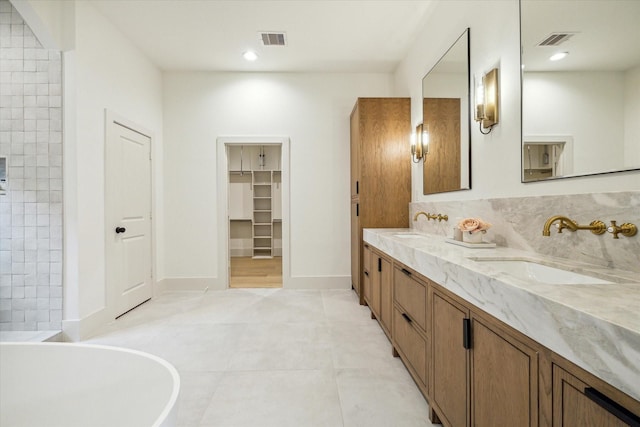 6227 Grovewood Ln, Houston, TX 77008 - bathroom featuring double vanity, a soaking tub, tile patterned floors, a walk in closet, and recessed lighting