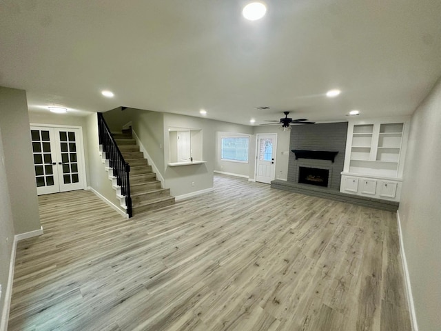 5507 Mossy Timbers Dr, Humble, TX 77346 - unfurnished living room with stairway, french doors, ceiling fan, light wood-style flooring, and recessed lighting