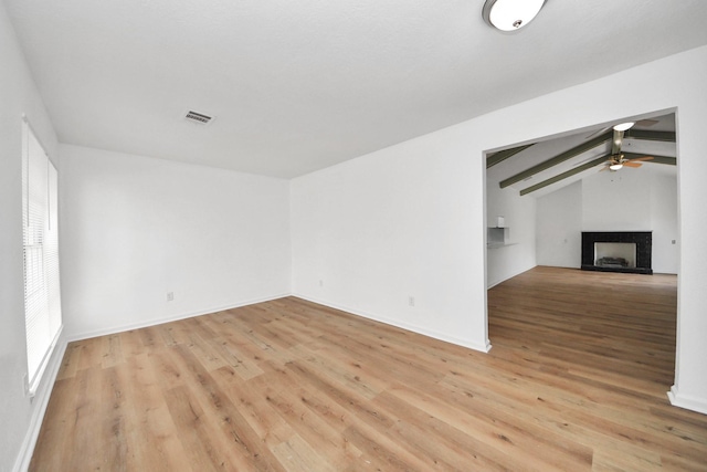 9250 Wiloak St, Houston, TX 77028 - unfurnished living room with a ceiling fan, light wood finished floors, and a fireplace
