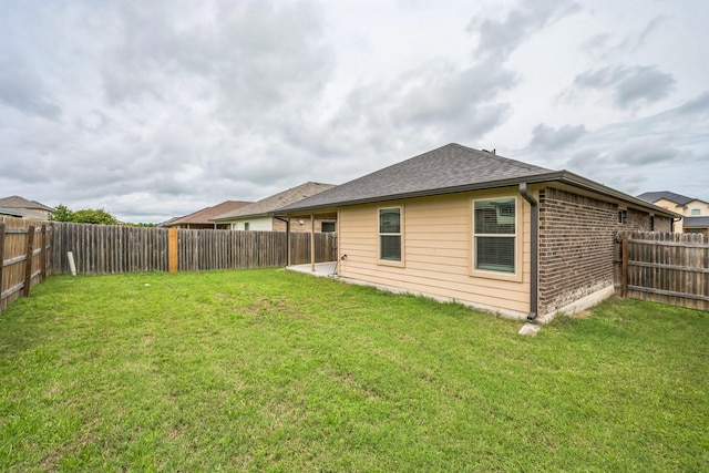 6328 Dorothy Muree Dr, Temple, TX 76502 - back of property featuring a fenced backyard, brick siding, and roof with shingles