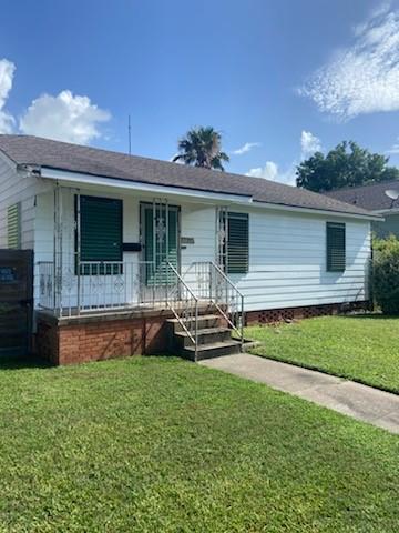 5514 Borden Ave, Galveston, TX 77551 - ranch-style house featuring a front lawn and covered porch