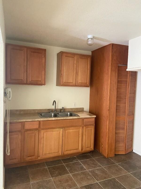 5514 Borden Ave, Galveston, TX 77551 - kitchen featuring a sink and brown cabinets