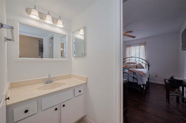 1505 Ward Rd Unit 118, Baytown, TX 77520 - bathroom featuring a textured ceiling, vanity, wood finished floors, and a ceiling fan